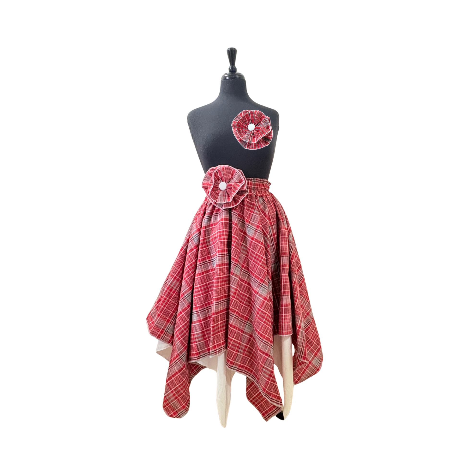 Women’s cultural Jamaican skirt in red, white, and blue plaid, reversible white lining, and flower accent detail at waist and optional flower brooch.