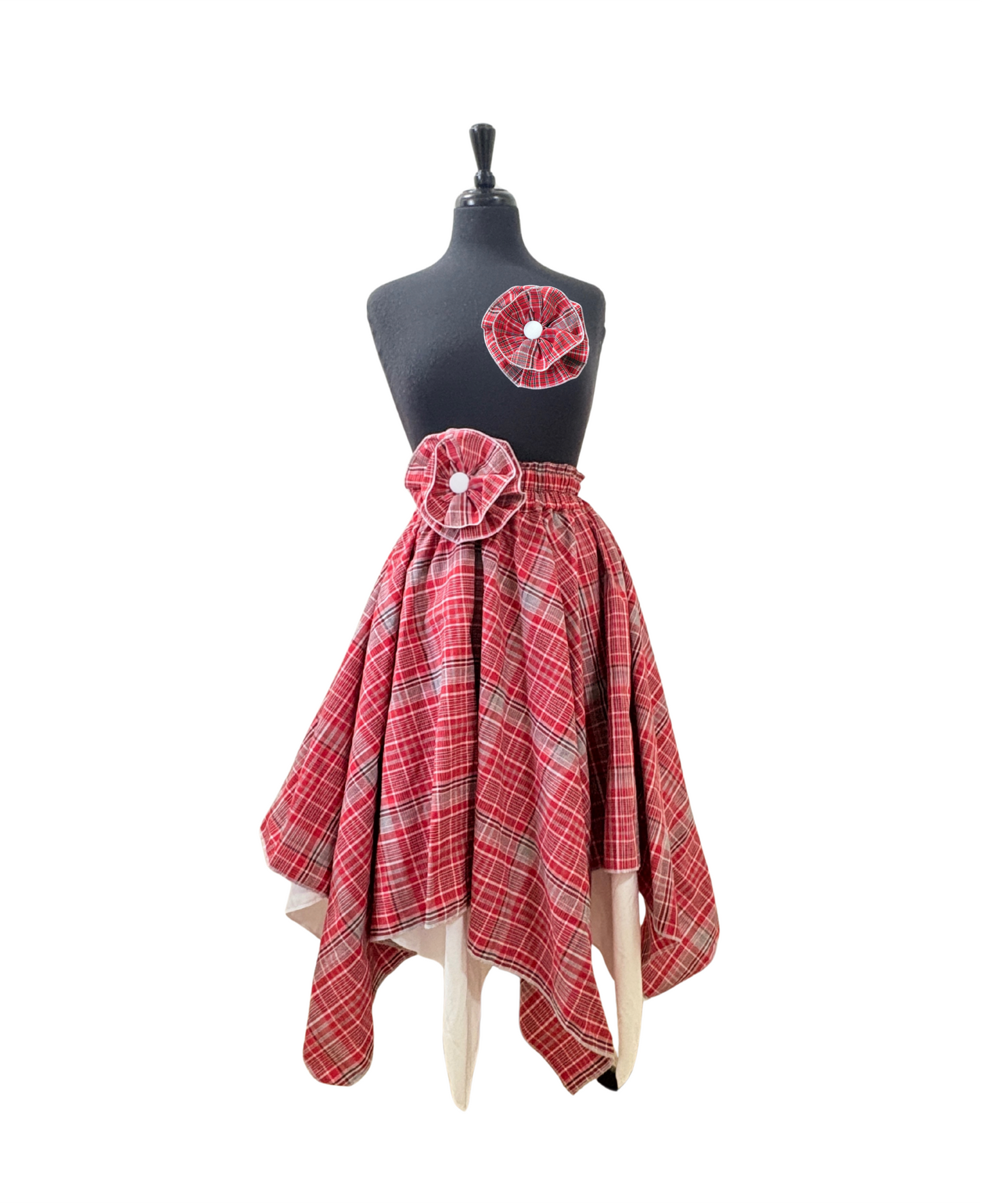 Women’s cultural Jamaican skirt in red, white, and blue plaid, reversible white lining, and flower accent detail at waist and optional flower brooch.