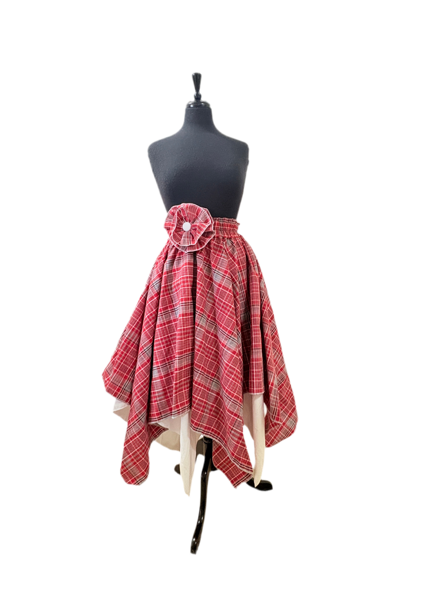 Women’s cultural Jamaican skirt in red, white, and blue plaid, reversible white lining, and flower accent detail at waist and optional flower brooch.