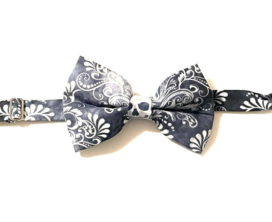 Black skulls bow tie with a purposely faded print. Skulls may fall anywhere on the bow tie