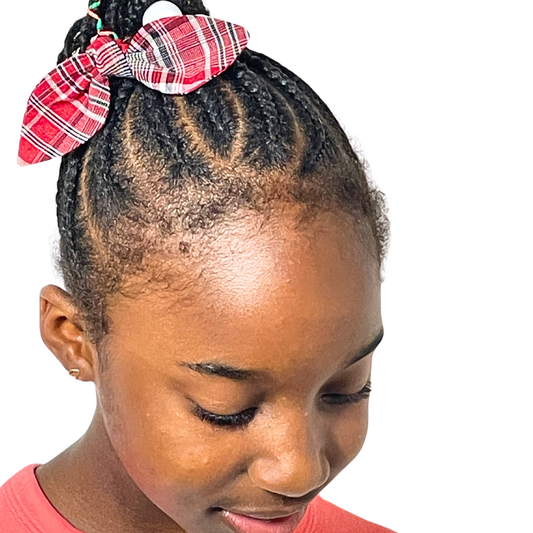 Model is wearing the Jamaican bandana print medium knotted bow.