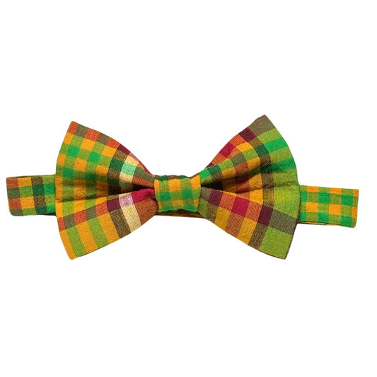Caribbean creole madras plaid bow tie with green, red, and yellow colors on a white background