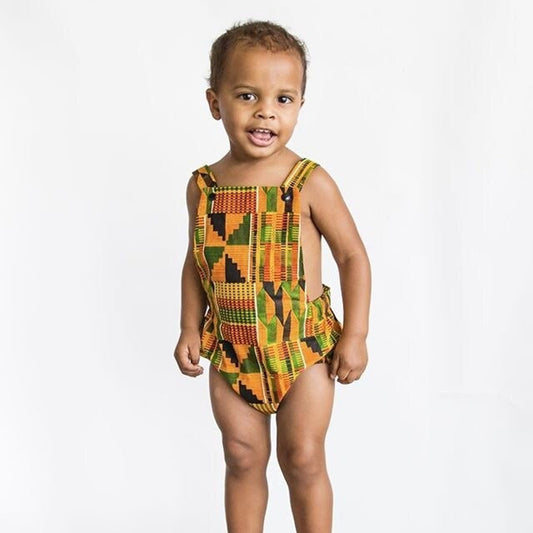 African American toddler wearing a Kente African print one-piece baby romper
