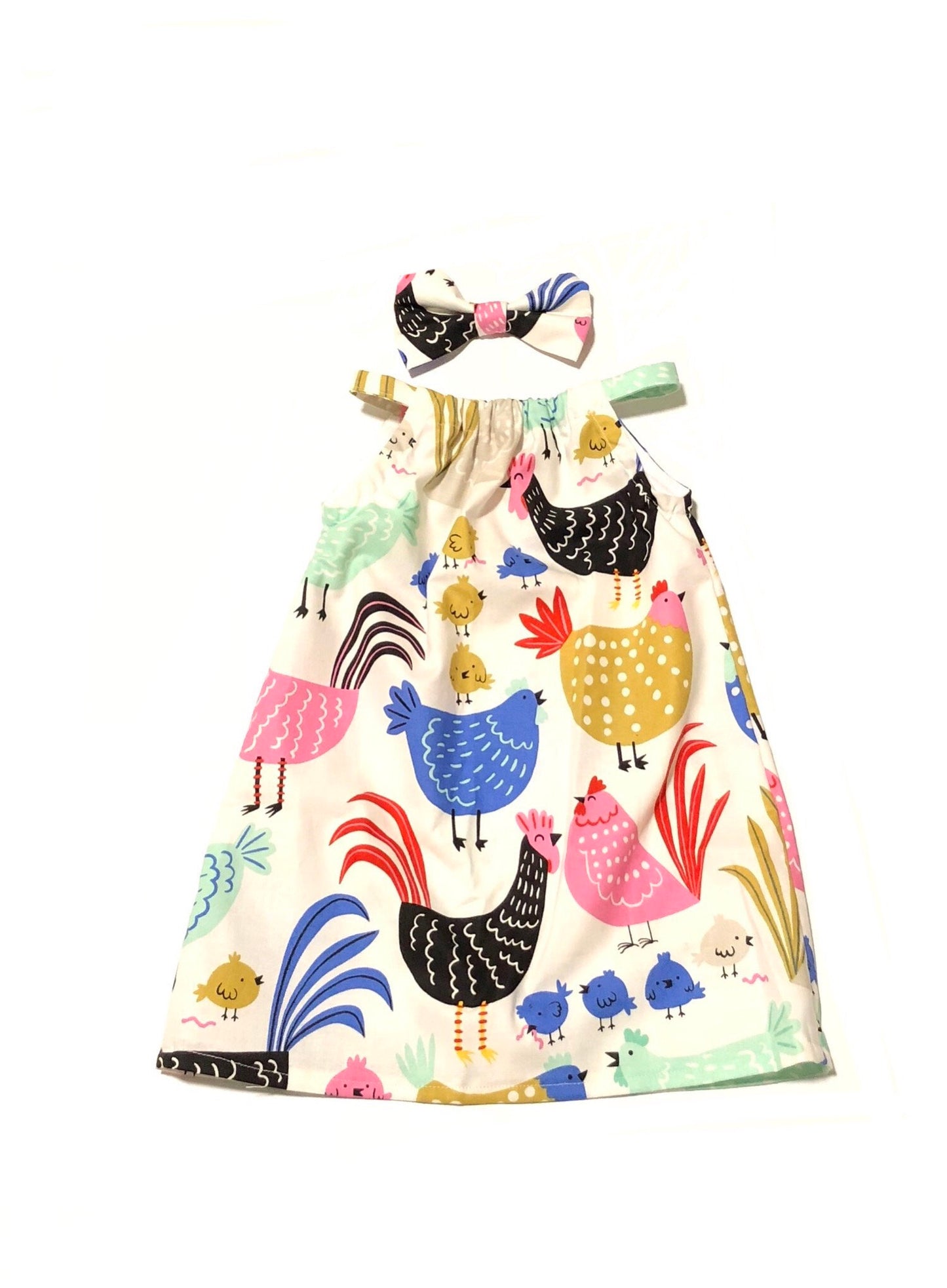 Off white pillowcase a-line dress with chicken print and comes with a matching hair bow.