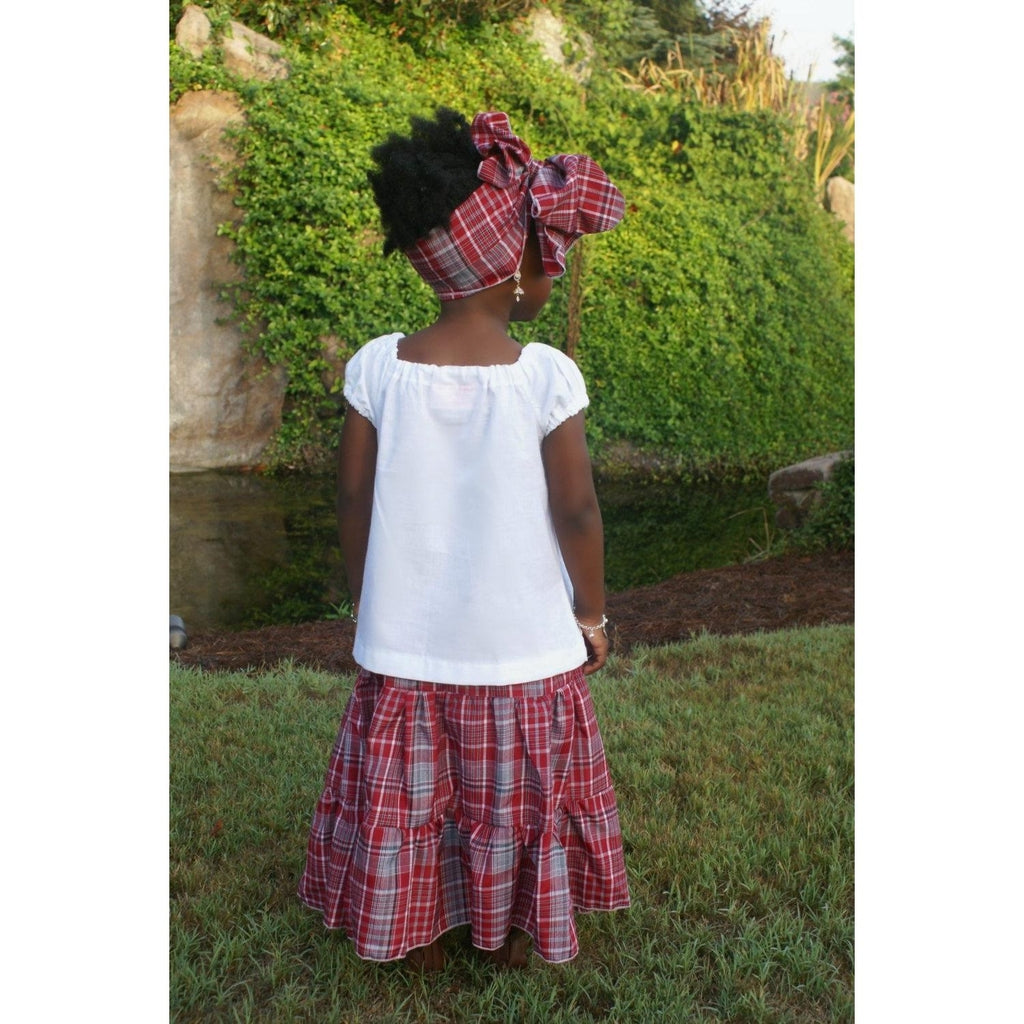 Rear view of a Traditional Jamaican bandana skirt with a white peasant top and a head wrap for girls