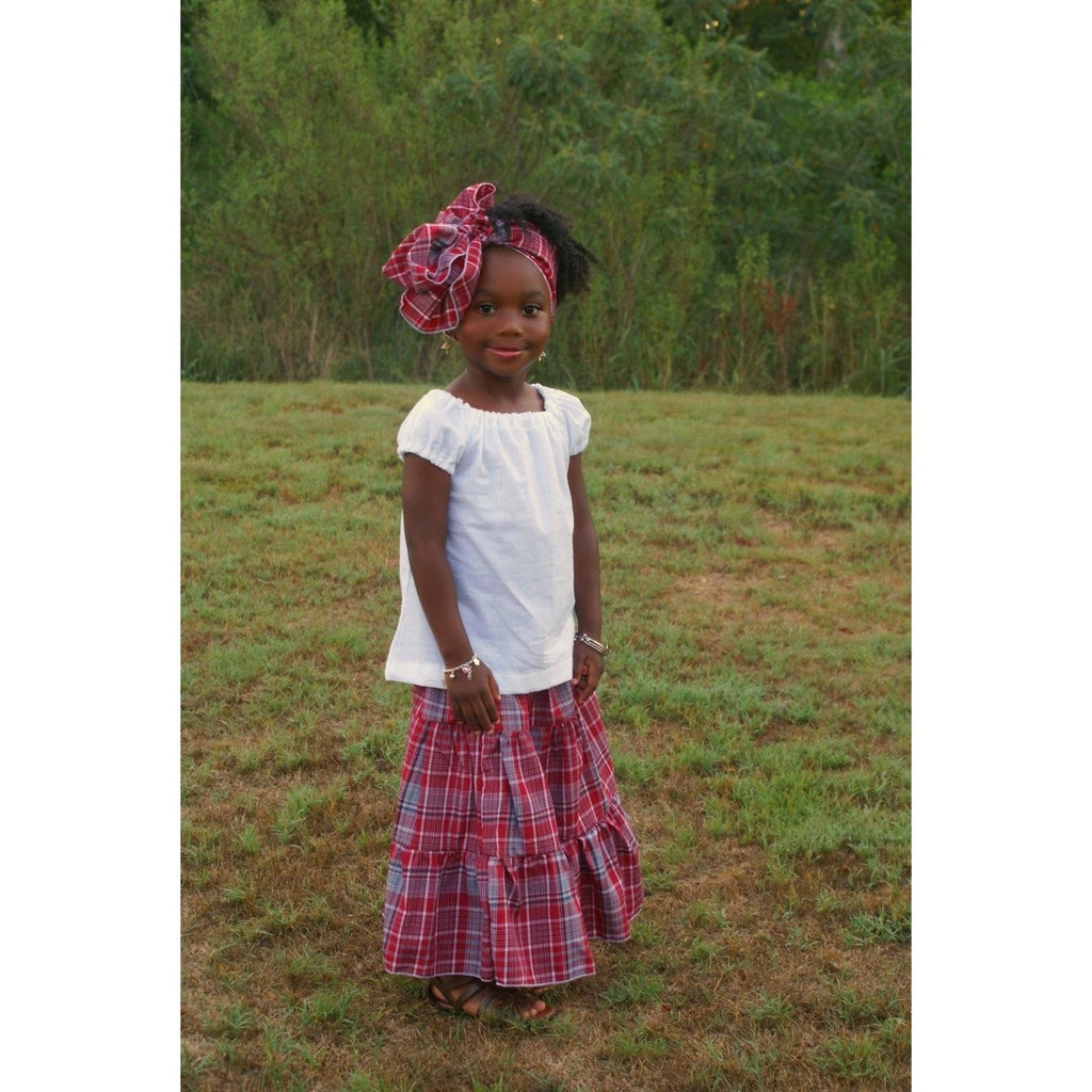 Side view of Traditional Jamaican bandana skirt with a white peasant top and a head wrap for girls