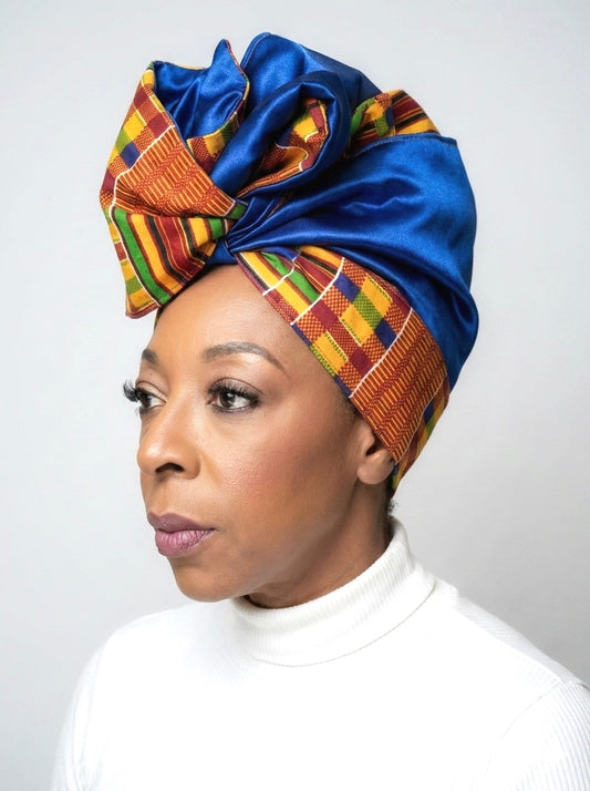 Owner of Ackee Tree Clothing modeling her own Orange Kente multi color patterned wired headwrap with a royal blue vegan satin lining.  