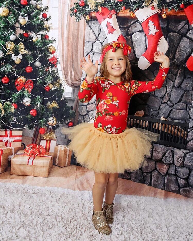 Little girl wearing a red holiday long sleeved floral leotard and matching headband.