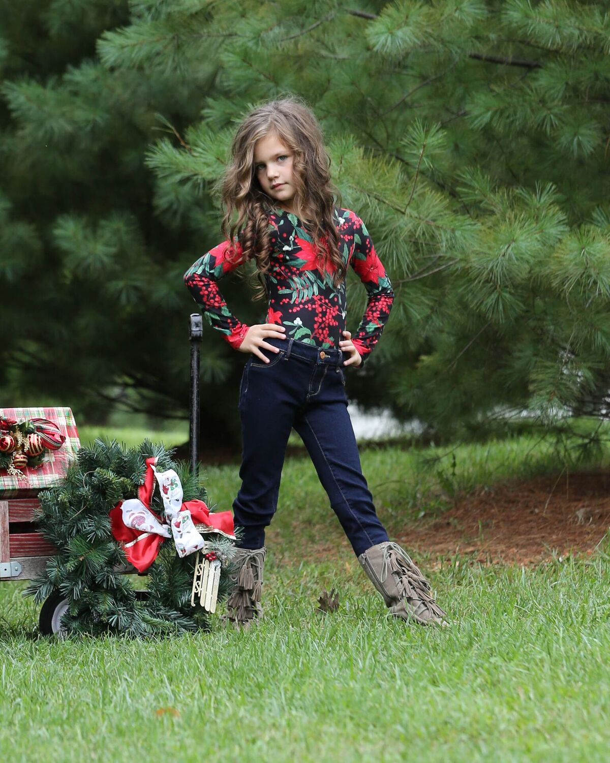 Girl wearing poinsettia leotard and jeans for Christmas 