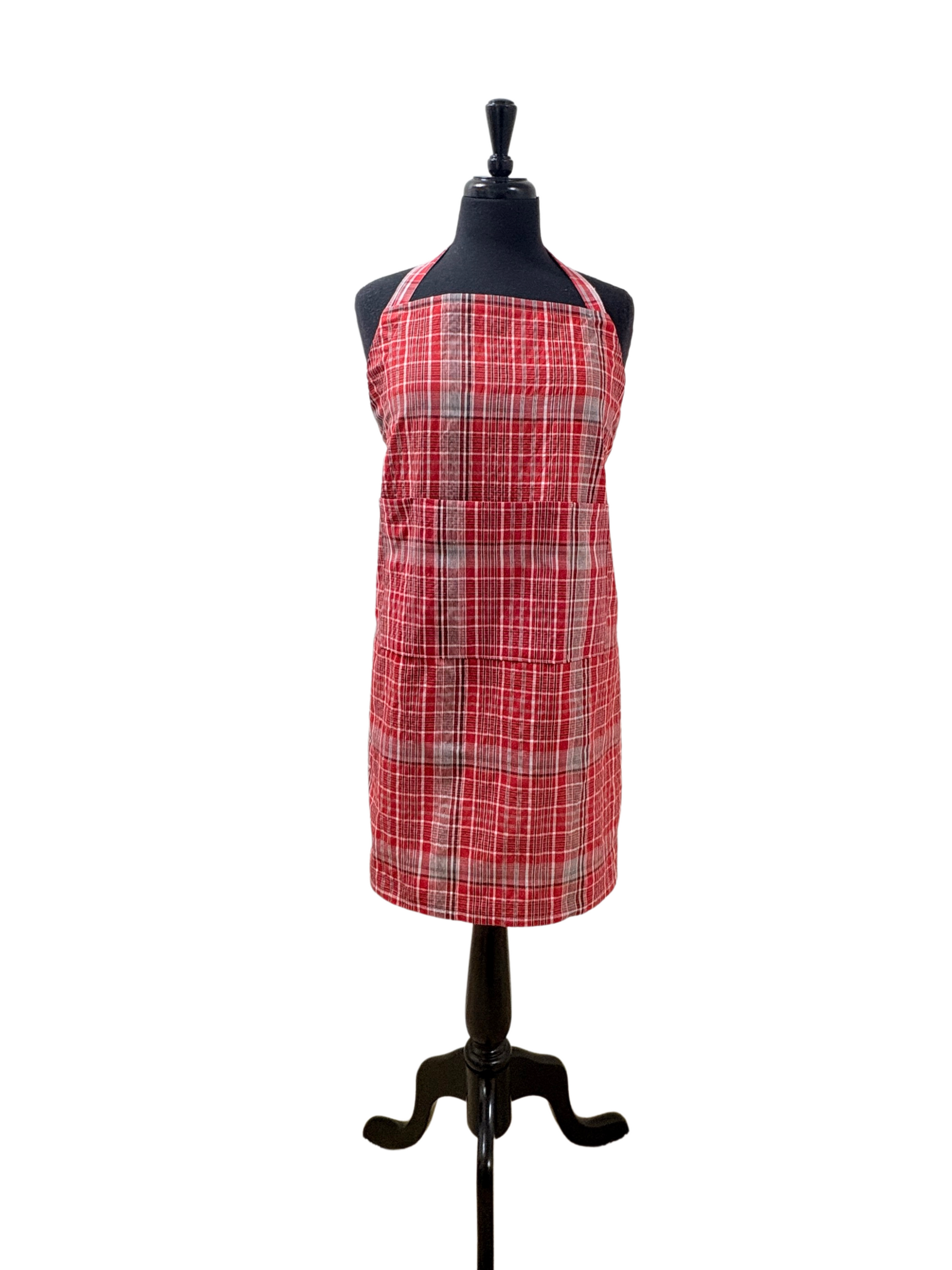Unisex Jamaican bandana apron in red, blue, and white plaid, featuring an adjustable no-knot neck strap, long waist ties, and three-section pocket. Handmade cultural kitchen apron for cooking, BBQ grilling, or gifting. Sizes Teen/XS to 3XL