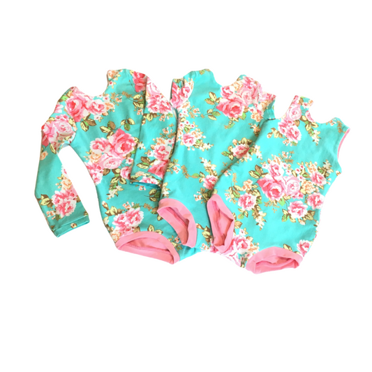 Three sleeve options for this aqua with pink floral design leotard for girls 