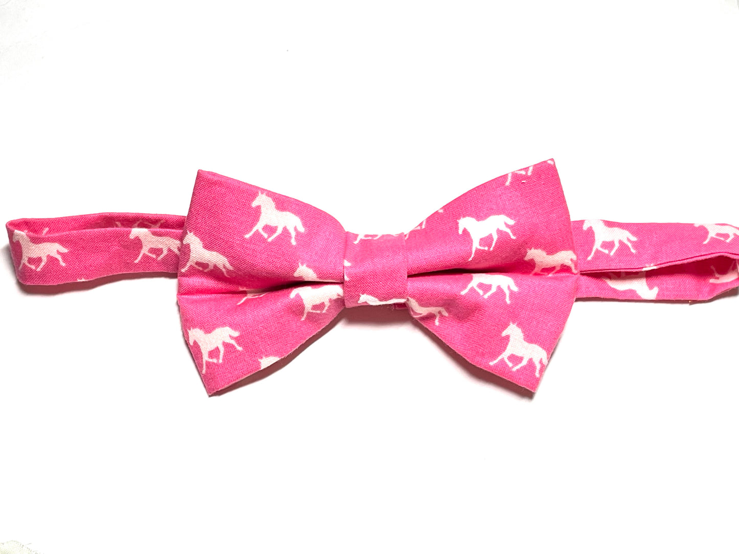 A dark pink self tie bow tie with a horse print, suitable for men's fashion and horse racing events.