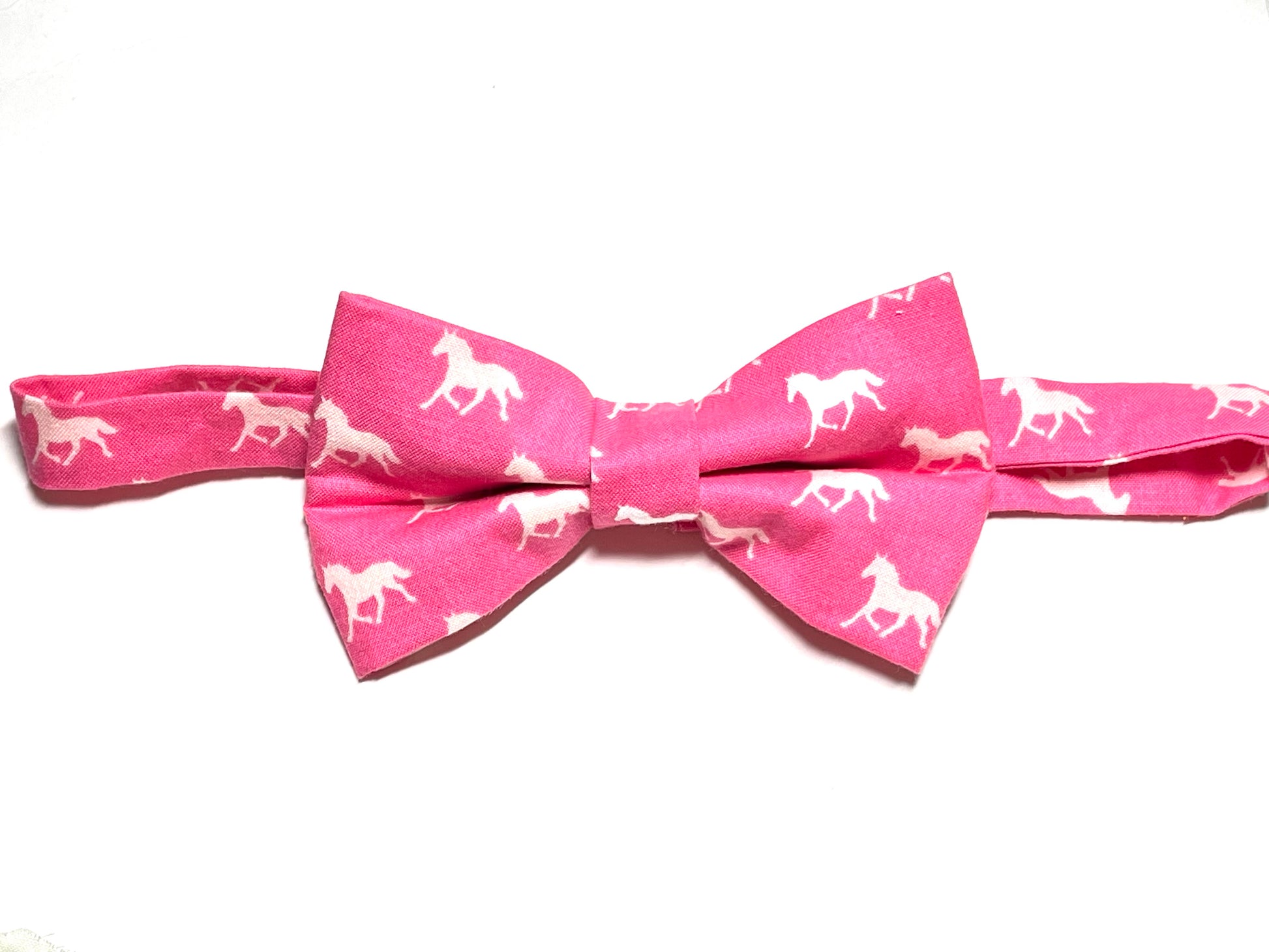 A dark pink self tie bow tie with a horse print, suitable for men's fashion and horse racing events.