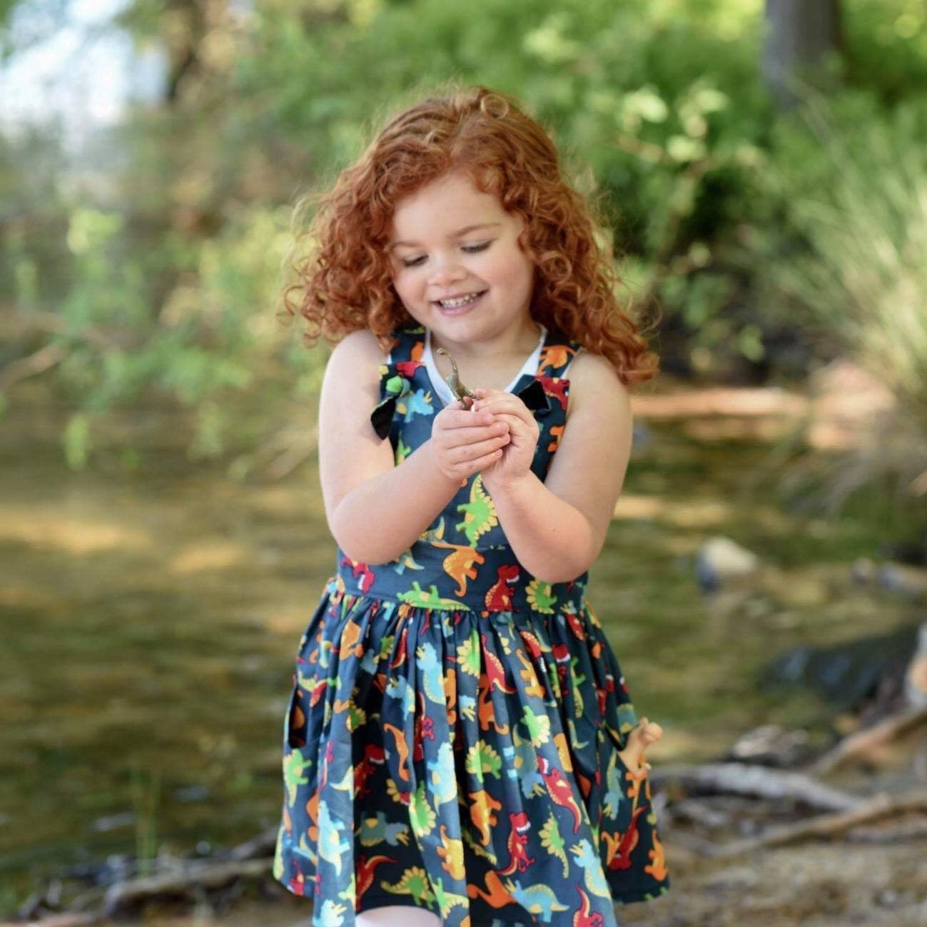 Navy Dinosaur print pinafore dress.