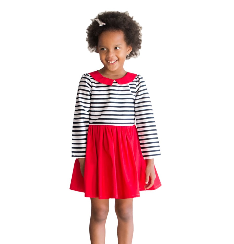 Little girl wearing a girl’s Red Dress with Black and White Striped Bodice and a red collar.