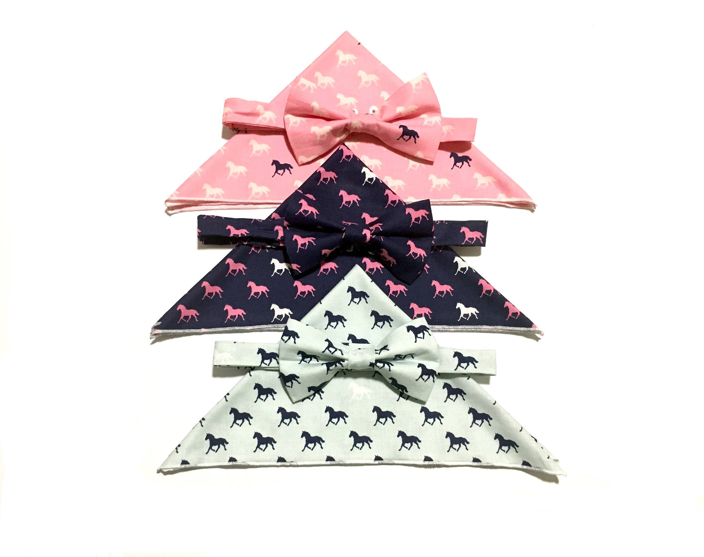 Men’s and boys derby horses print pre-tied bow ties with matching pocket squares in the colors aqua, pink and navy with different colored horses on the print.